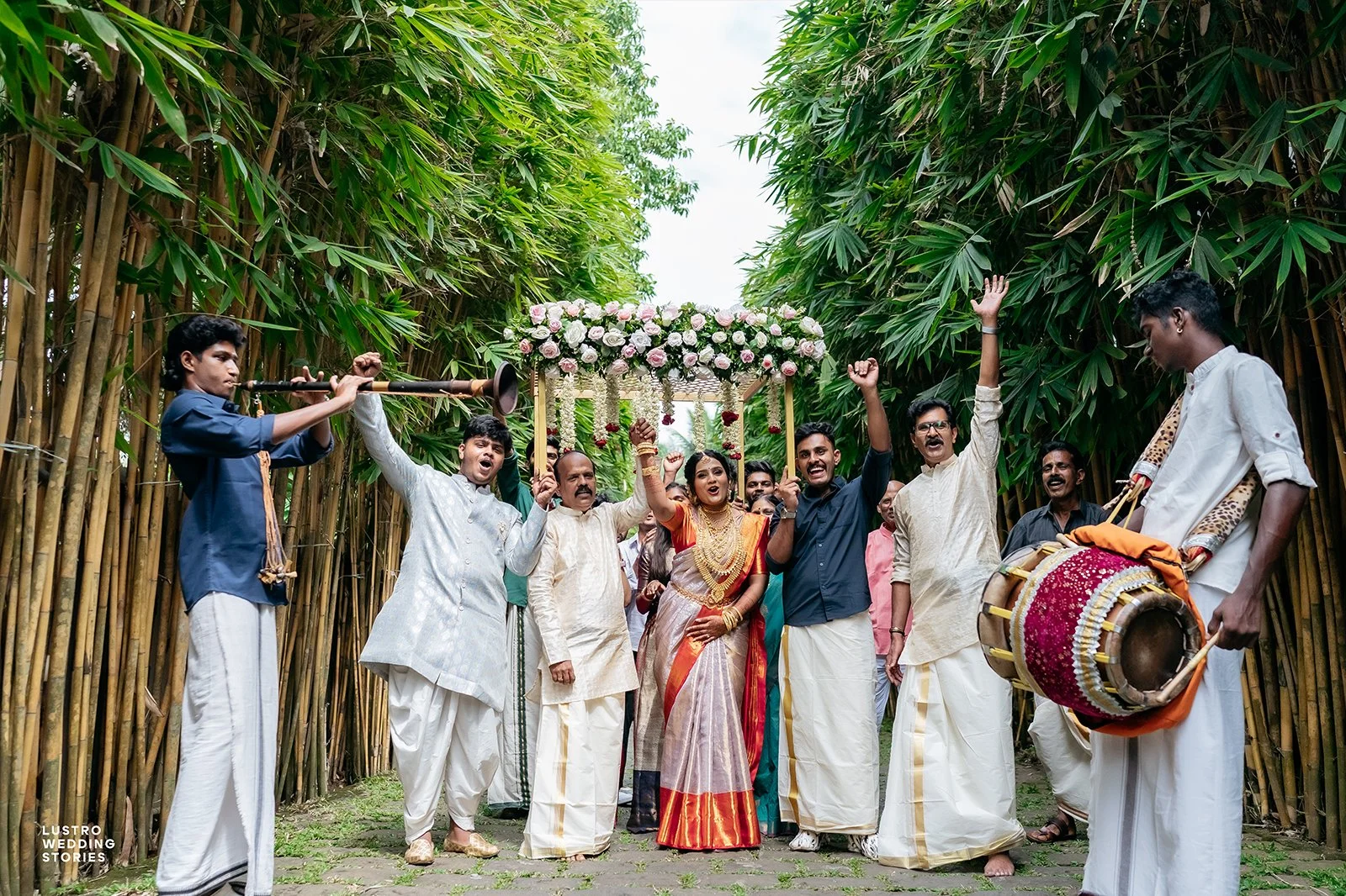 Guruvayur Temple Wedding Joyful couple with traditional music troupe and family celebrating with nadaswaram and chenda melam during their Guruvayur temple marriage procession