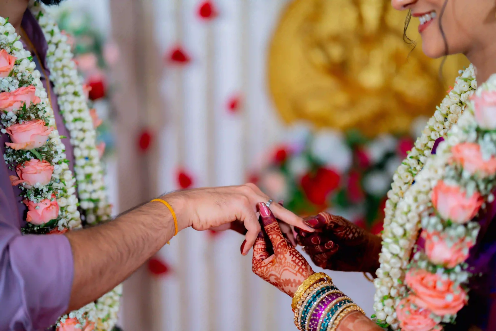 Traditional wedding rituals with a bride and groom exchanging rings during a beautifully decorated wedding at guruvayur